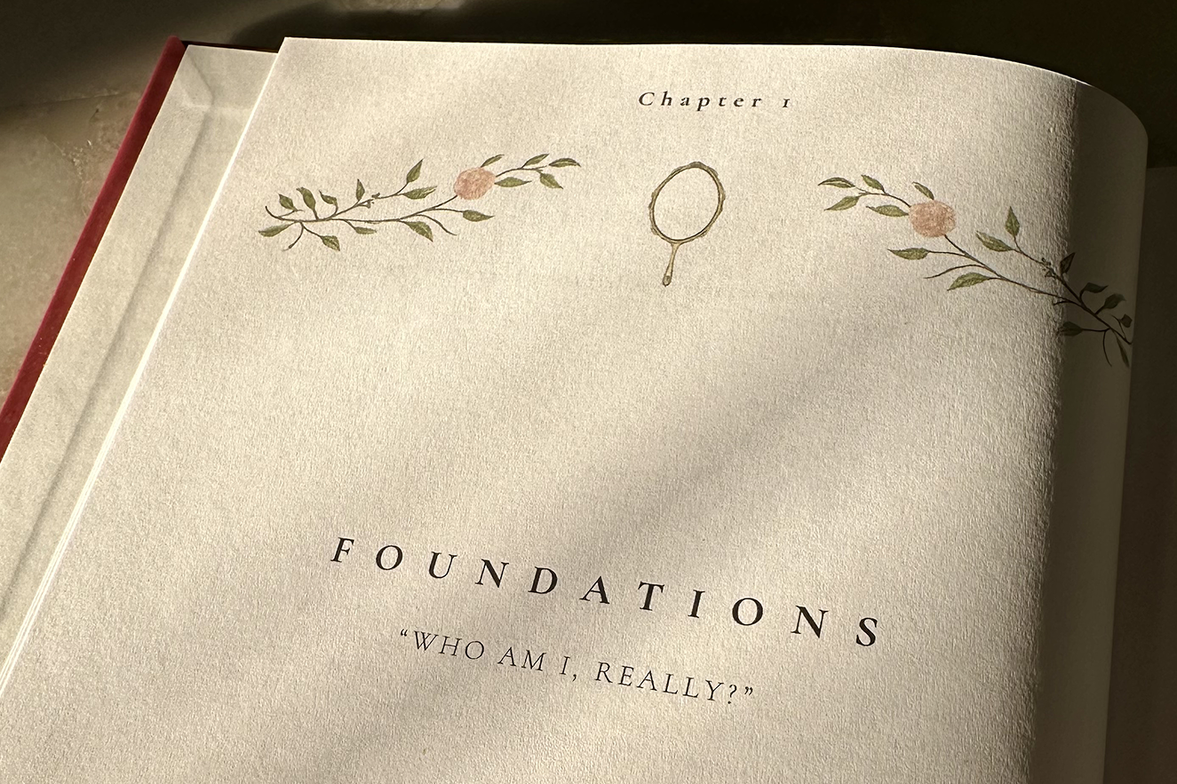 Book open to a page titled 'Foundations: Who Am I, Really?' with decorative elements.