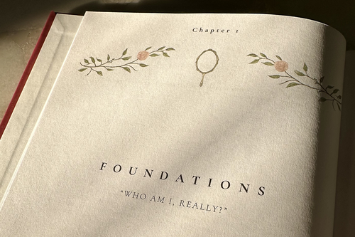 Book open to a page titled 'Foundations: Who Am I, Really?' with decorative elements.